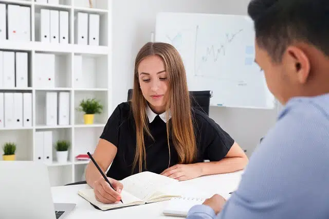coworkers taking notes and working together