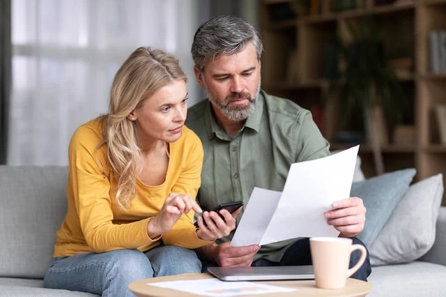 middle aged couple reviewing financial statements 640